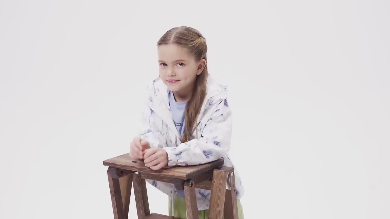 Момиче в светлосиня рокля държи голям букет бели цветя в есенно-зимна фотосесия на Gulliver.